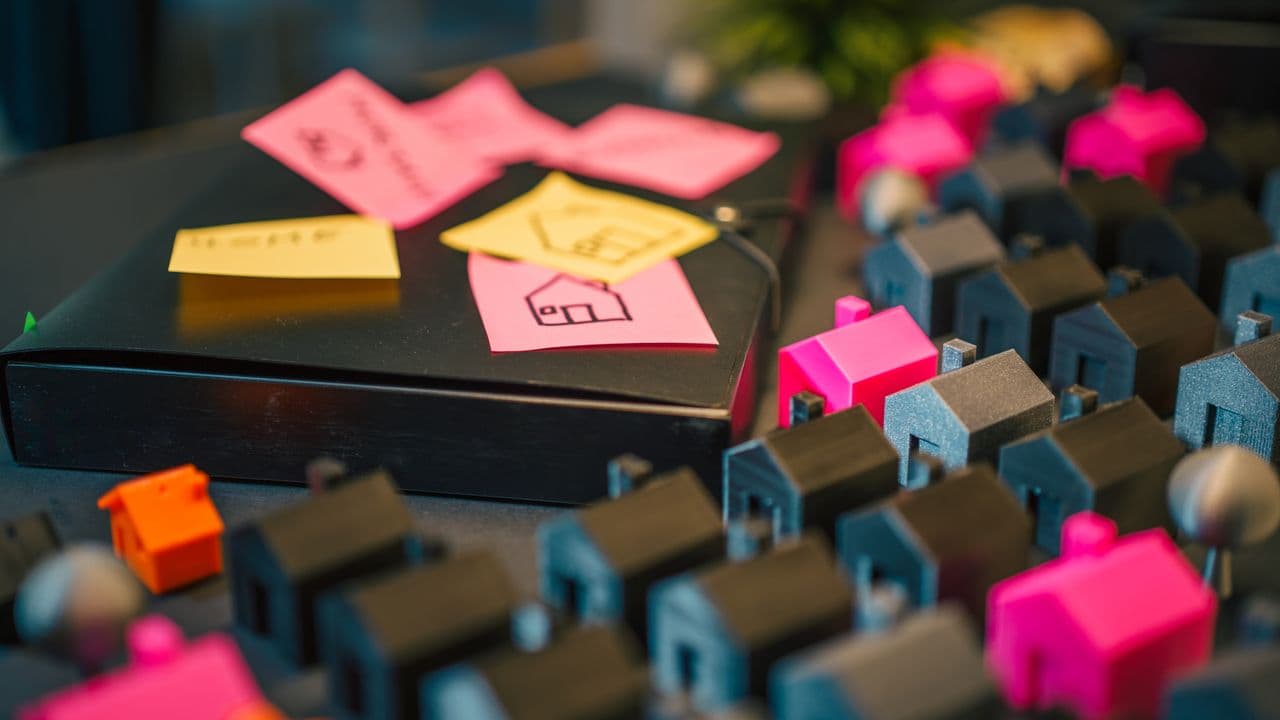 House models, keys, and documents arranged for real estate planning